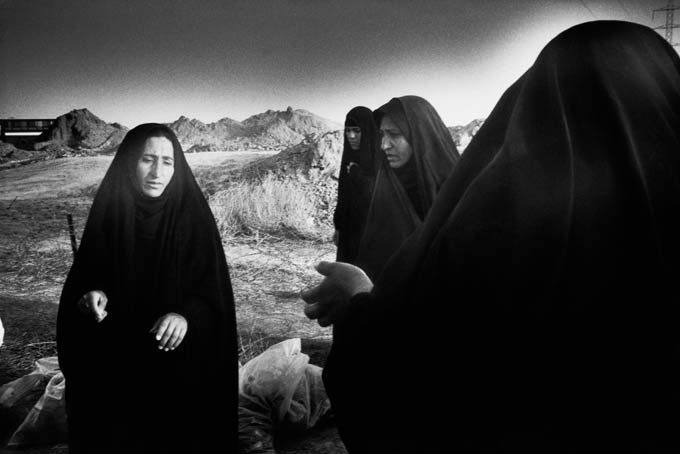 Shia women gathered in a field of body bags