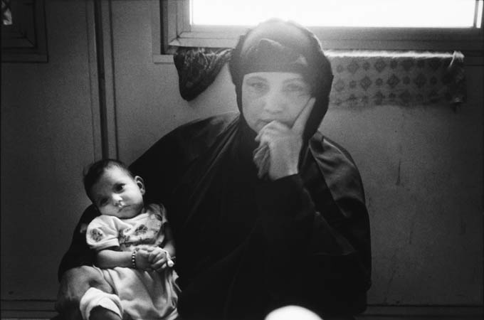 An Iraqi woman with her dying infant
