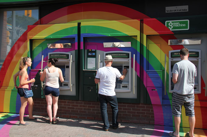 TD Bank ATMs decorated with rainbows for Pride Month in Toronto. Photo by flickr user Canadian Pacific. June 21, 2014.