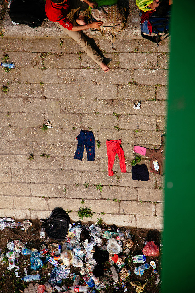A group of refugees under the bridge in Belgrade's Savamala district. They use the river to wash themselves and their clothes. The area  has since then been closed off as a construction site, part of the often disputed "Belgrade Waterfront" project. July 2015. Author Luka Knežević Strika (Belgrade Raw).