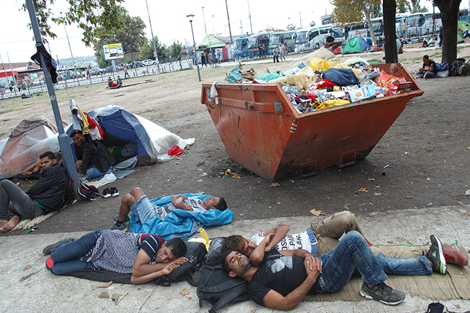 8 am in the park which is the sleeping place for most of the refugees who arrive to Belgrade. Most of the people are already awake but this group of young men still sleeps despite the traffic noise and morning chill. September 2015. Author Jelena Mijič (Belgrade Raw).