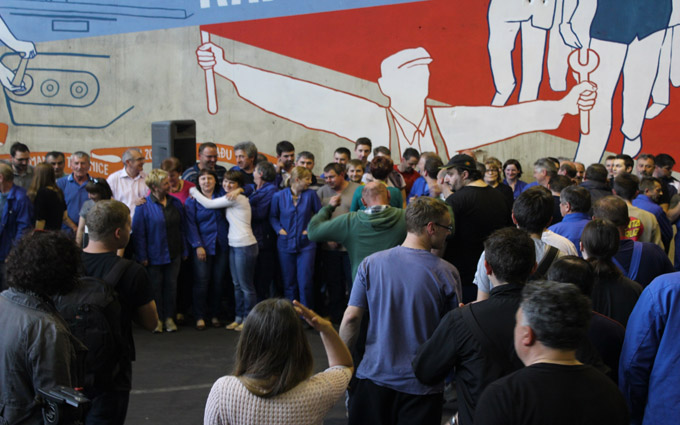 Workers gather in front of the mural. Photo by Matija Kralj.